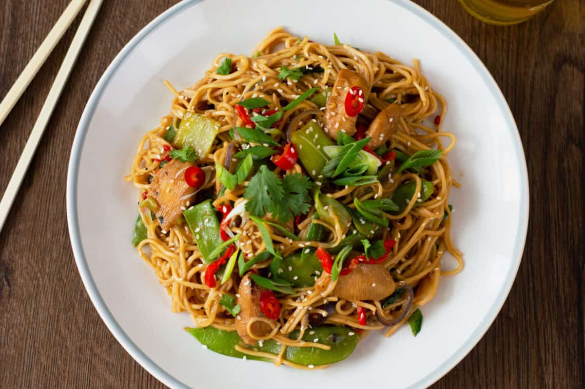 A photo of my Chicken Stir-Fry with Noodles recipe with chop sticks in the background
