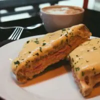 Croque-Monsieur sliced in half and garnished with sliced parsley