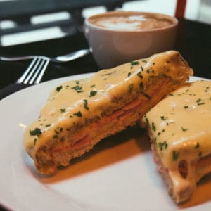 Croque-Monsieur sliced in half and garnished with sliced parsley
