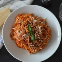 Spaghetti Bolognese in a bowl with basil