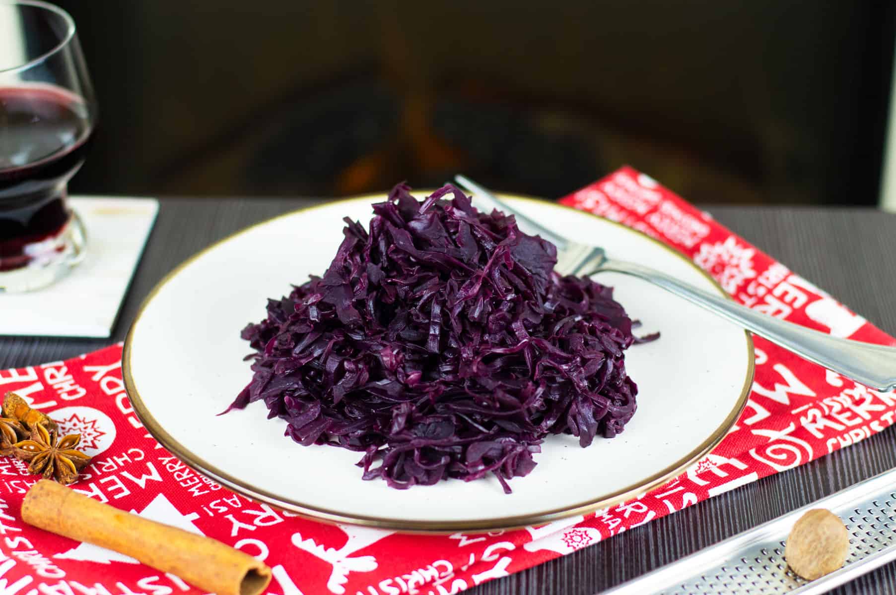 Braised Red Cabbage on a white plate next to spices
