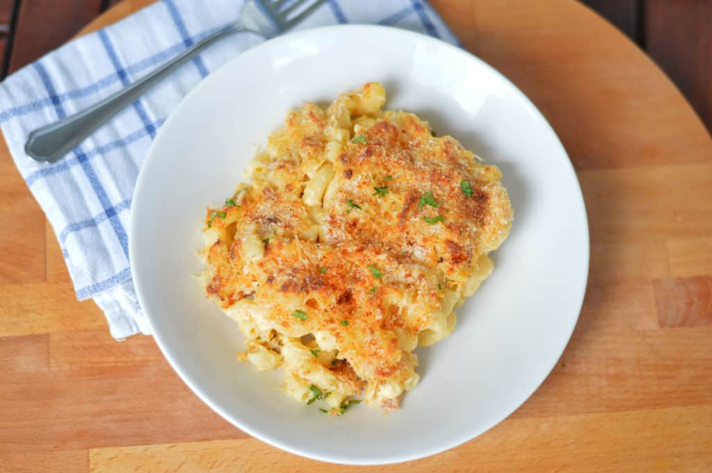 Bacon mac and cheese served on a white plate