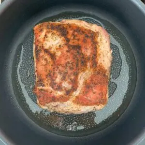 Searing the second side of the pork