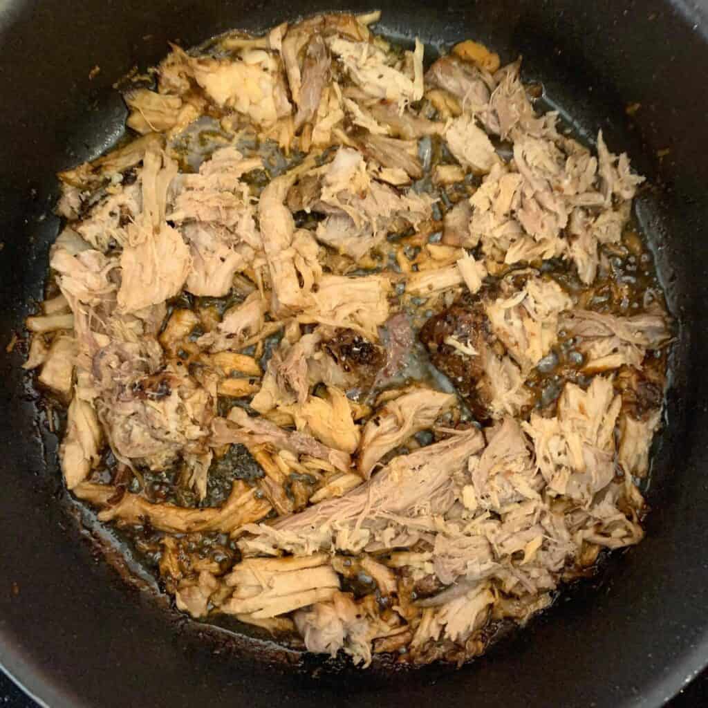 Crisping the pork in a sauté pan.