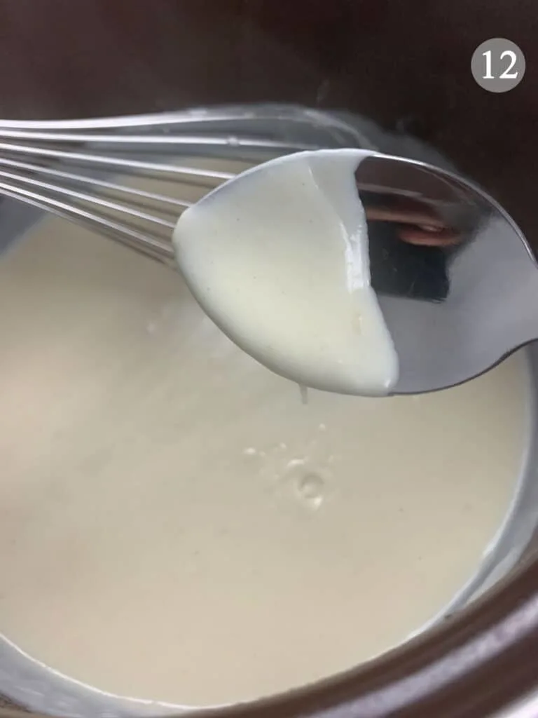 Checking the thickness of the bechamel sauce with a spoon