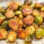 Brussels sprouts cooked and halved on a baking sheet