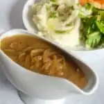 onion gravy in a white pourer
