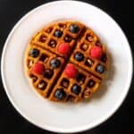 waffles on a white plate with berries