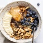 oatmeal, peanut butter, sliced banana and blueberries in a bowl