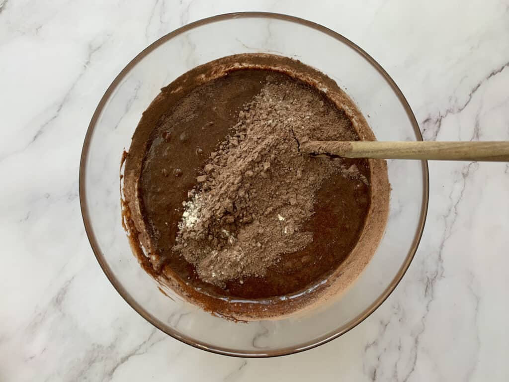 Adding the rest of the flour and cocoa to the batter