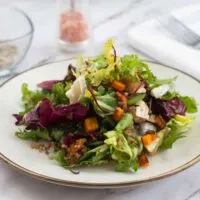 Small plate heaped with quinoa & butternut squash salad.