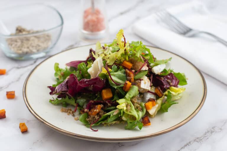 Small plate heaped with quinoa & butternut squash salad.