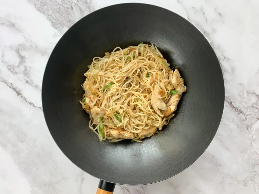 Stir fried chicken chow mein in a wok
