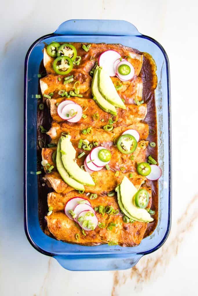 Baked enchiladas with avocado and jalapeno topping