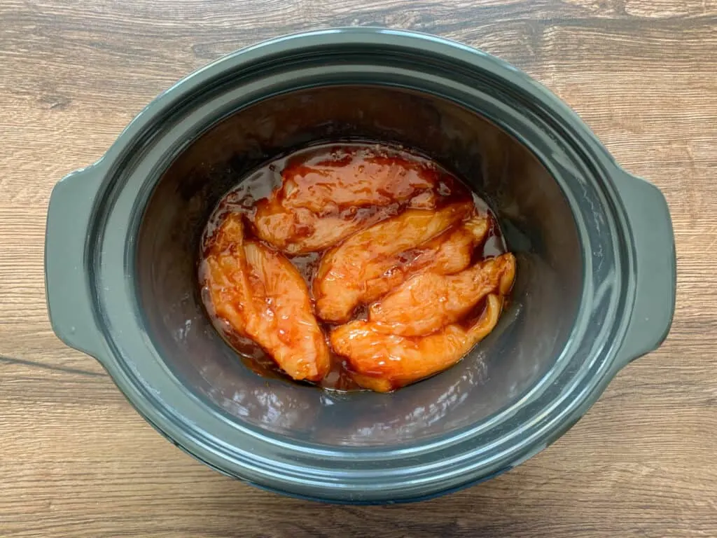 Mixing together the chicken and garlic bbq sauce