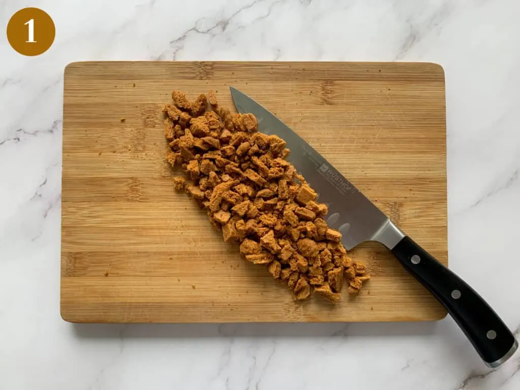 Biscoff biscuits roughly chopped on a wooden board