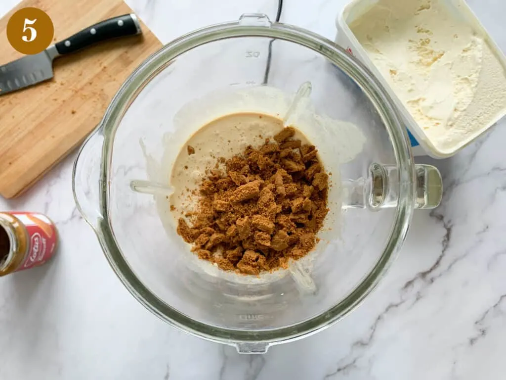 Adding biscoff biscuits to the milkshake