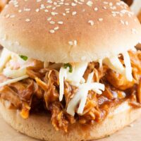 Slow cooked bbq chicken in a sesame seeded bun with coleslaw