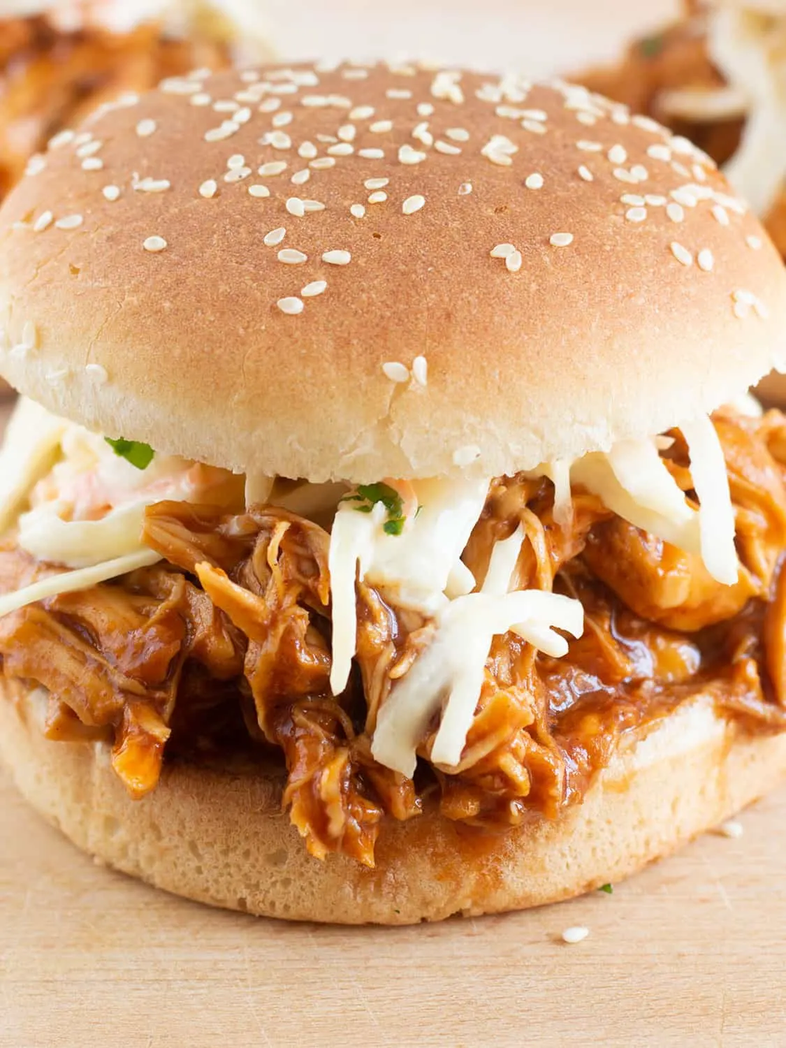 Slow cooked bbq chicken in a sesame seeded bun with coleslaw