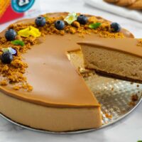 Biscoff cheesecake with a piece being lift out by a cake server