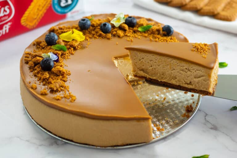 Biscoff cheesecake with a piece being lift out by a cake server
