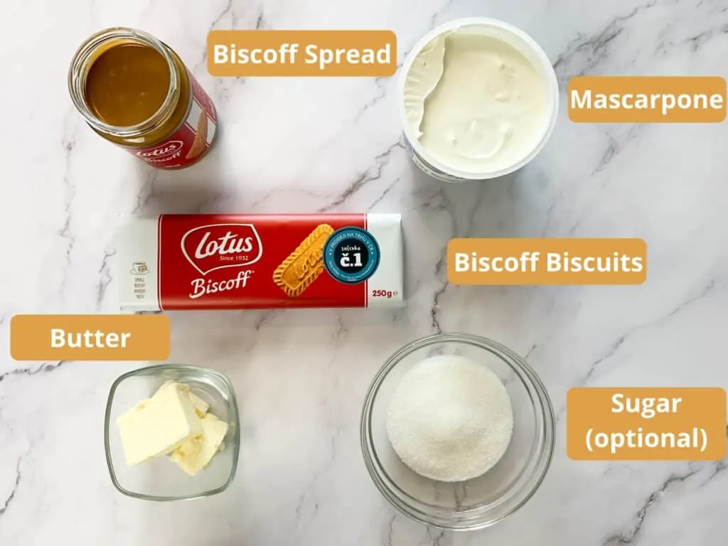 Biscoff spread, Biscoff biscuits, mascarpone, butter and sugar portioned on a marble surface