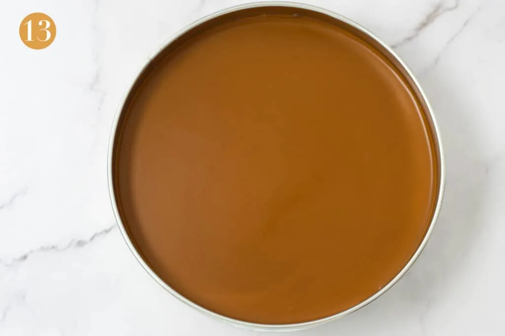 A set biscoff cheesecake in a cake tin