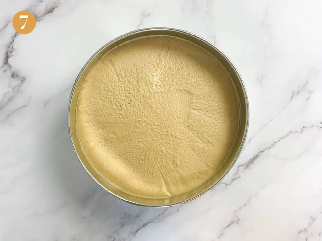 A smooth flat cheesecake in cake tin