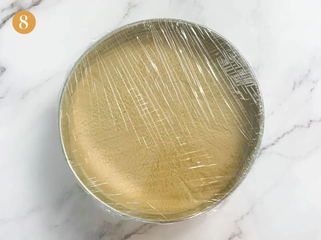 Heavily wrapped tight cling film over a cake tin