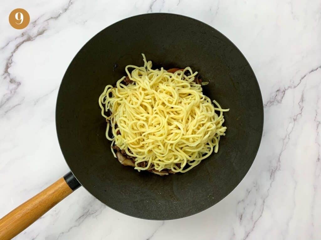 Wheat noodles with beef yakisoba in a wok