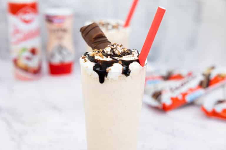 Kinder Bueno milkshake in a tall glass with a red straw