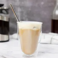 Salted caramel cream cold brew in a glass with a straw