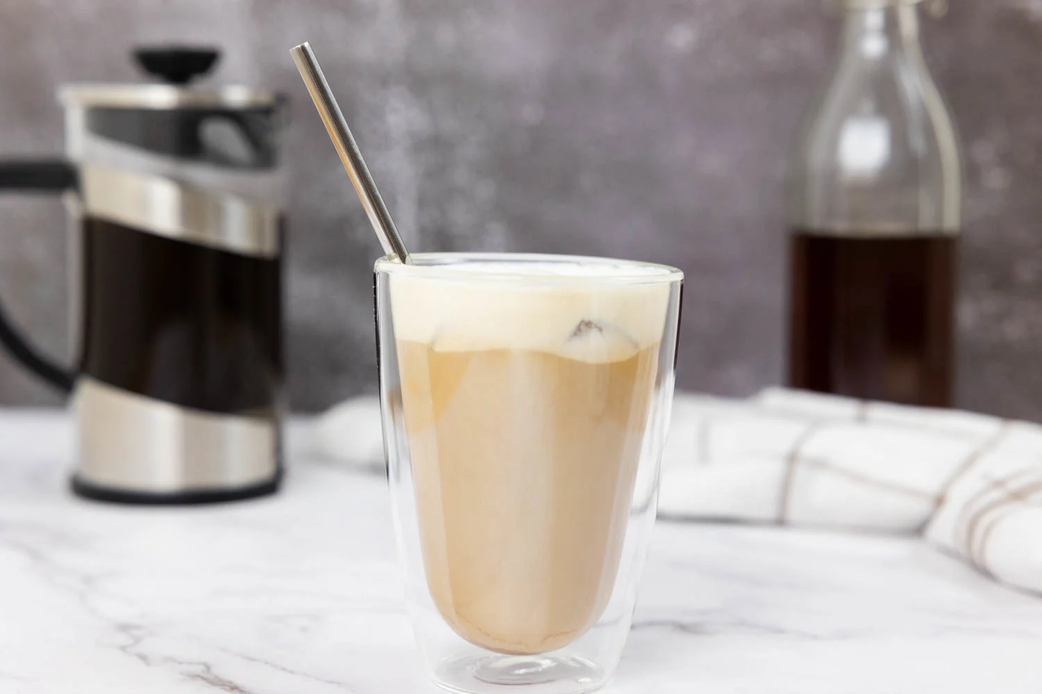 Salted caramel cream cold brew in a glass with a straw