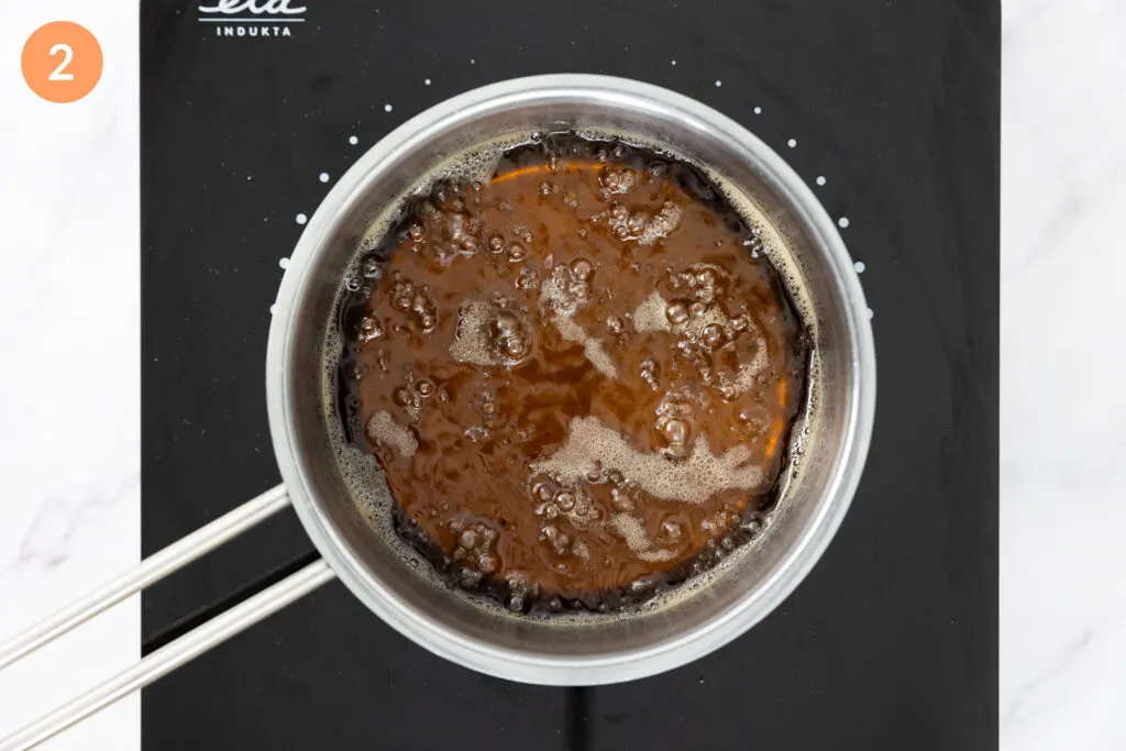 Vanilla syrup at boiling point in a small saucepan