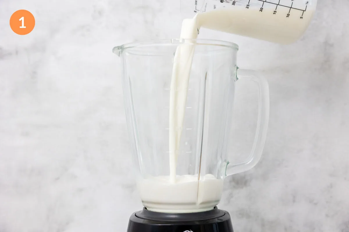 Pouring milk into a large blender