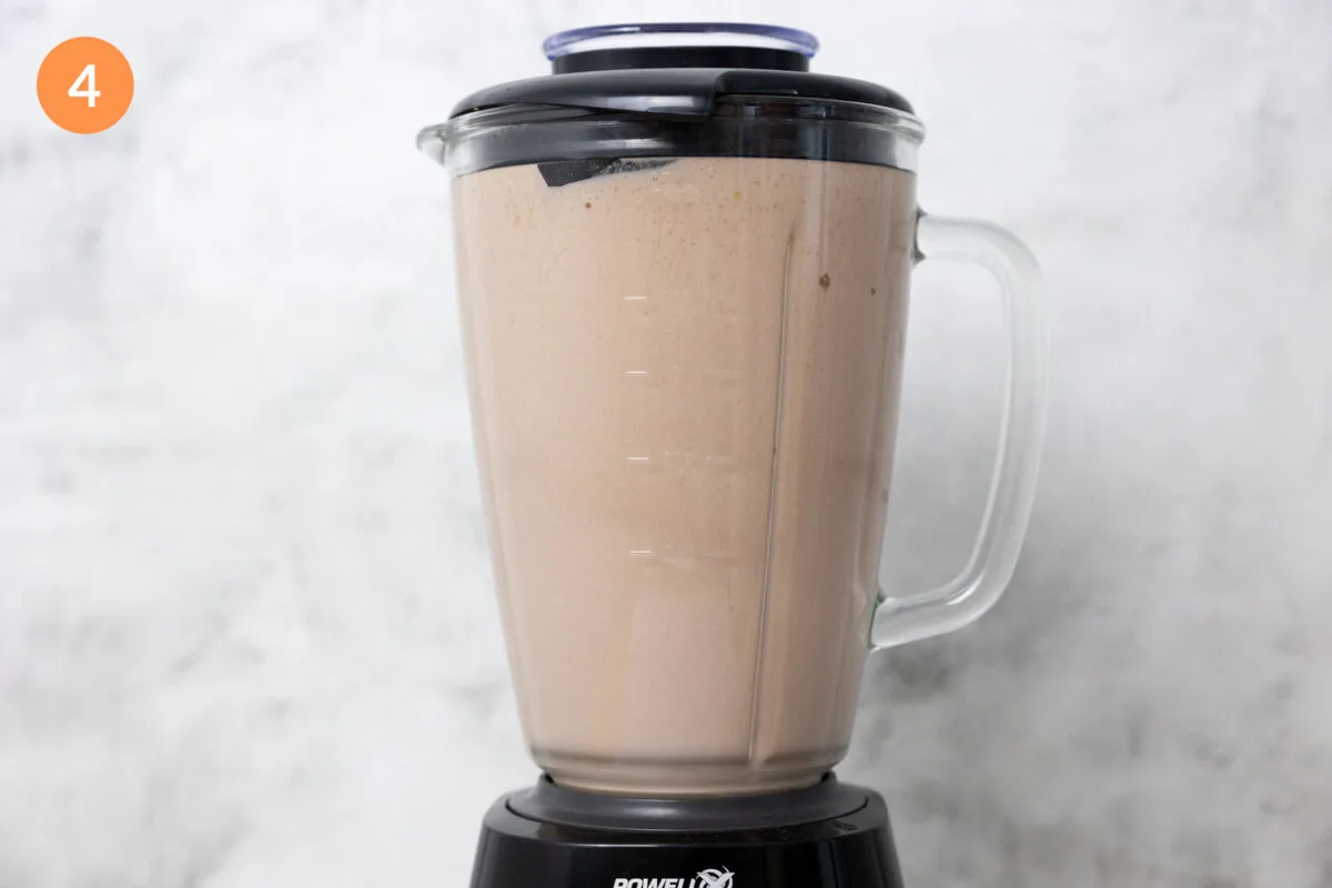 Blending together a weight gainer protein shake in a blender