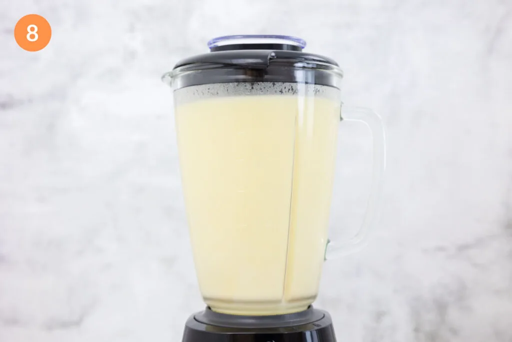 Potato soup that has been blended in a large blender