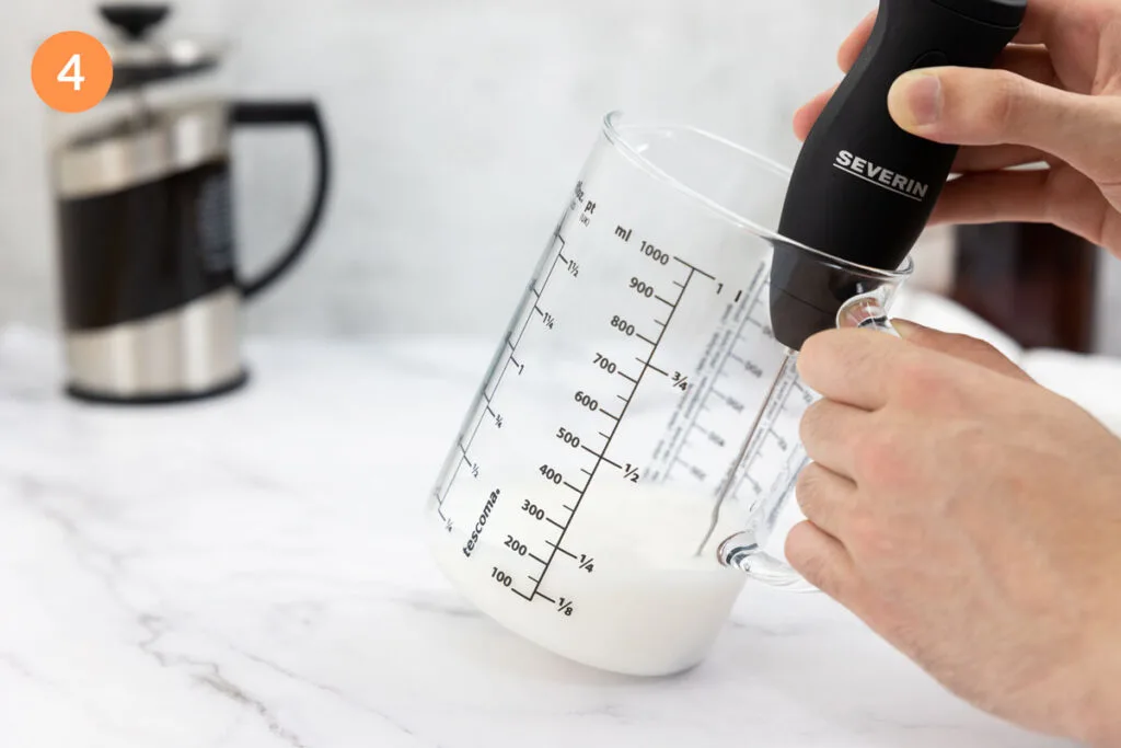 Vanilla syrup and milk doubled in volume in a jug