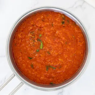 San Marzano tomato sauced with fresh basil in a saucepan
