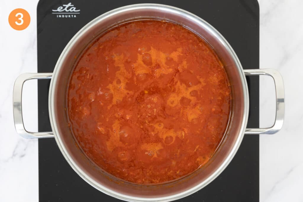 Tomato sauce slowly simmering in a pot