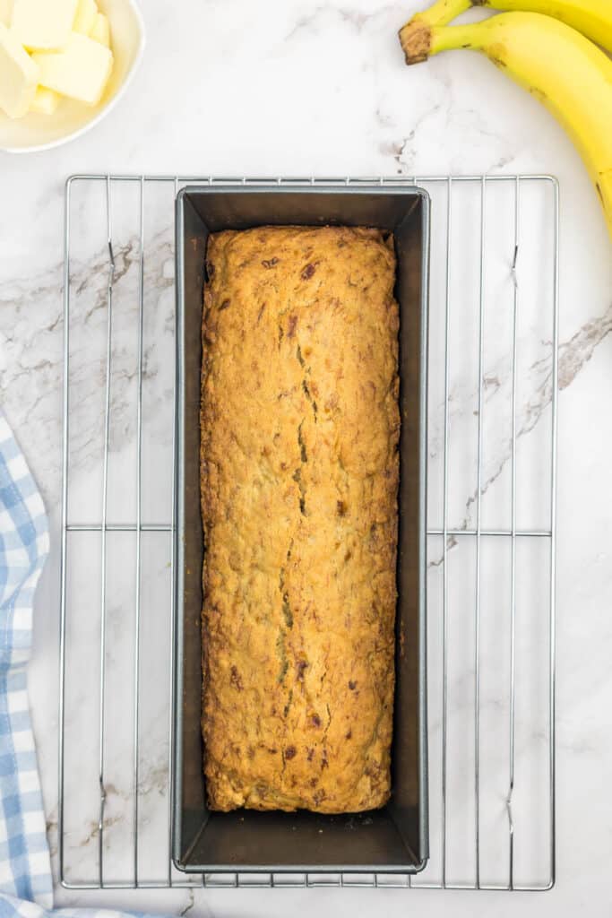 Baked banana bread without baking soda cooling in a loaf pan