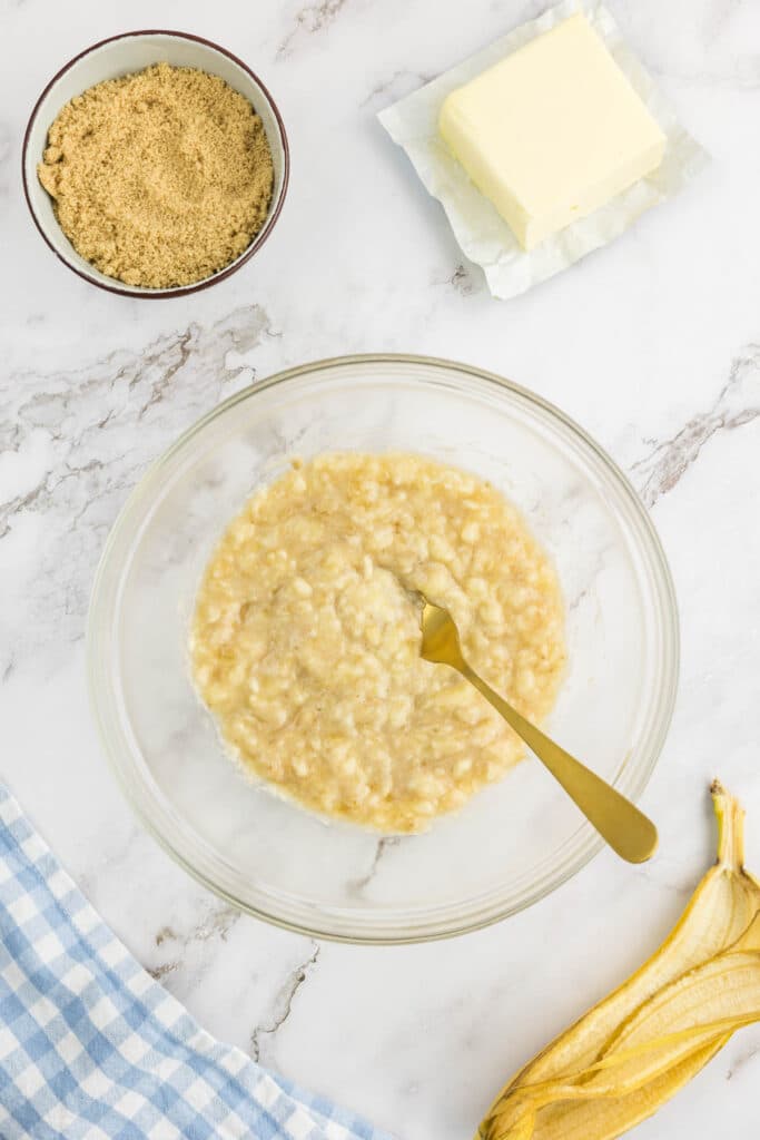 Mashed banana in a bowl with a fork