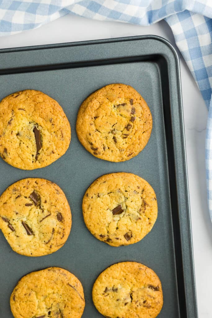 Freshly baked no brown sugar chocolate chip cookies on a baking tray