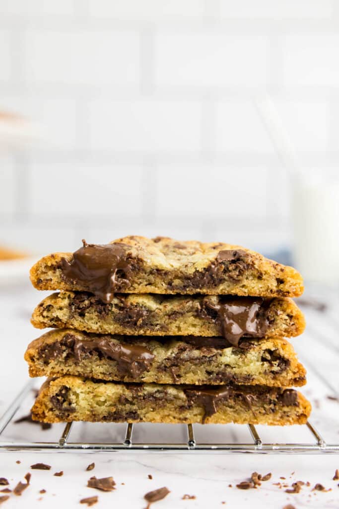 Chocolate chip cookies halved on a cooling rack