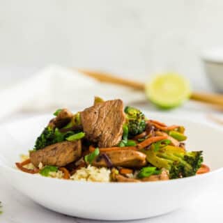 Keto chicken stir fry in a white bowl.