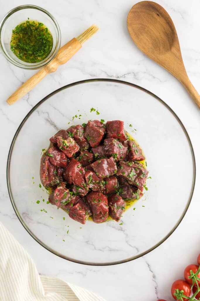 Beef steak marinading in a large bowl