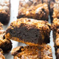 Biscoff brownie square leaning on top of another brownie