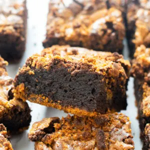 Biscoff brownie square leaning on top of another brownie