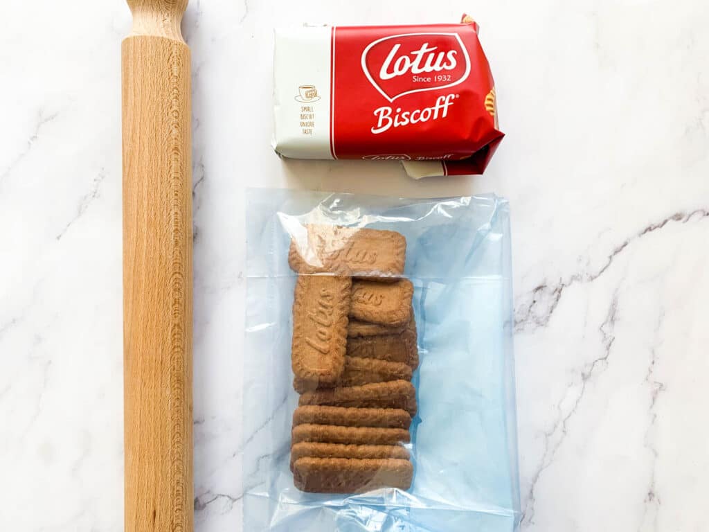 Biscoff lotus biscuits in a freezer bag with a rolling pin