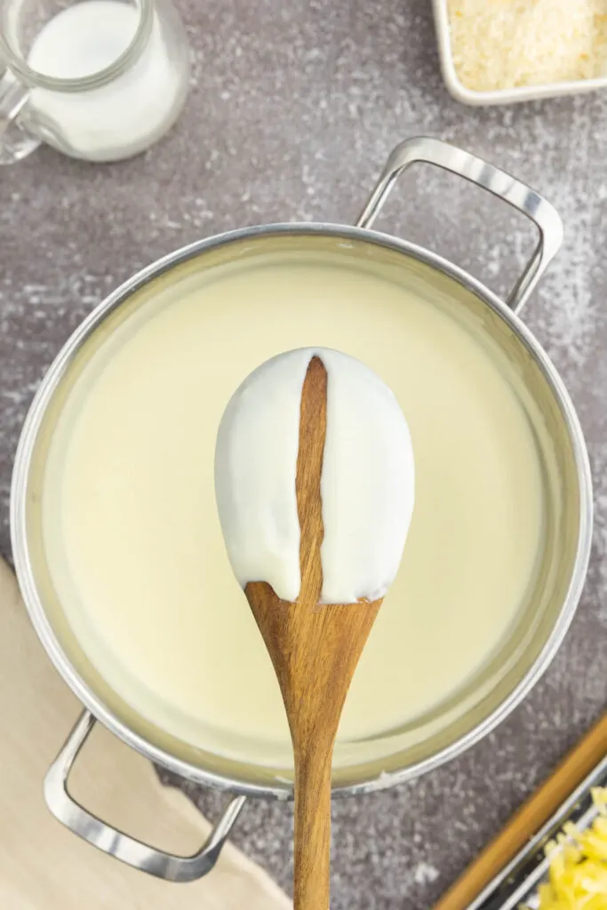Wooden spoon with a thickened bechamel sauce